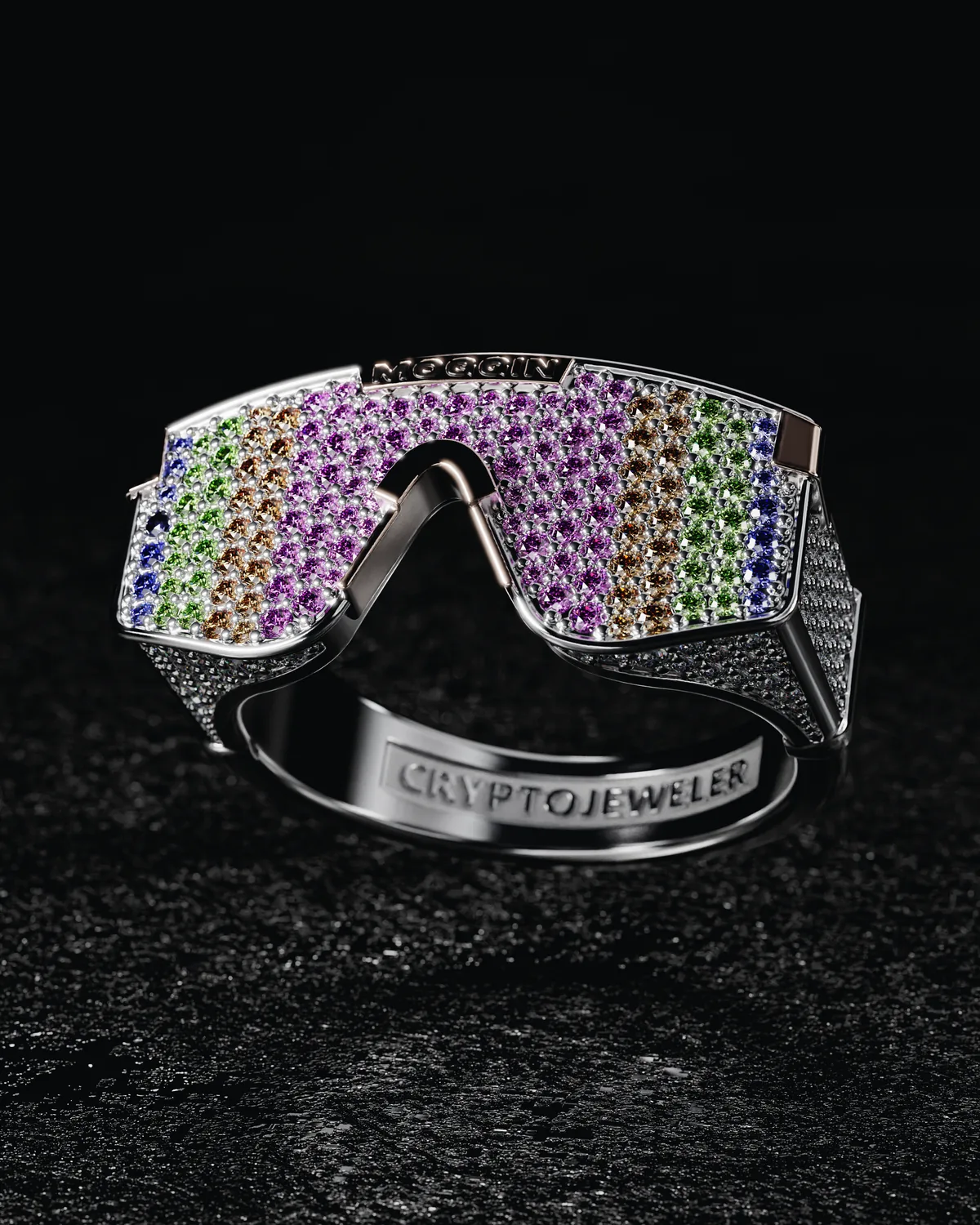 The MOG visor ring in white gold, the lens pavé set with multicolored stones, shot on a dark ground