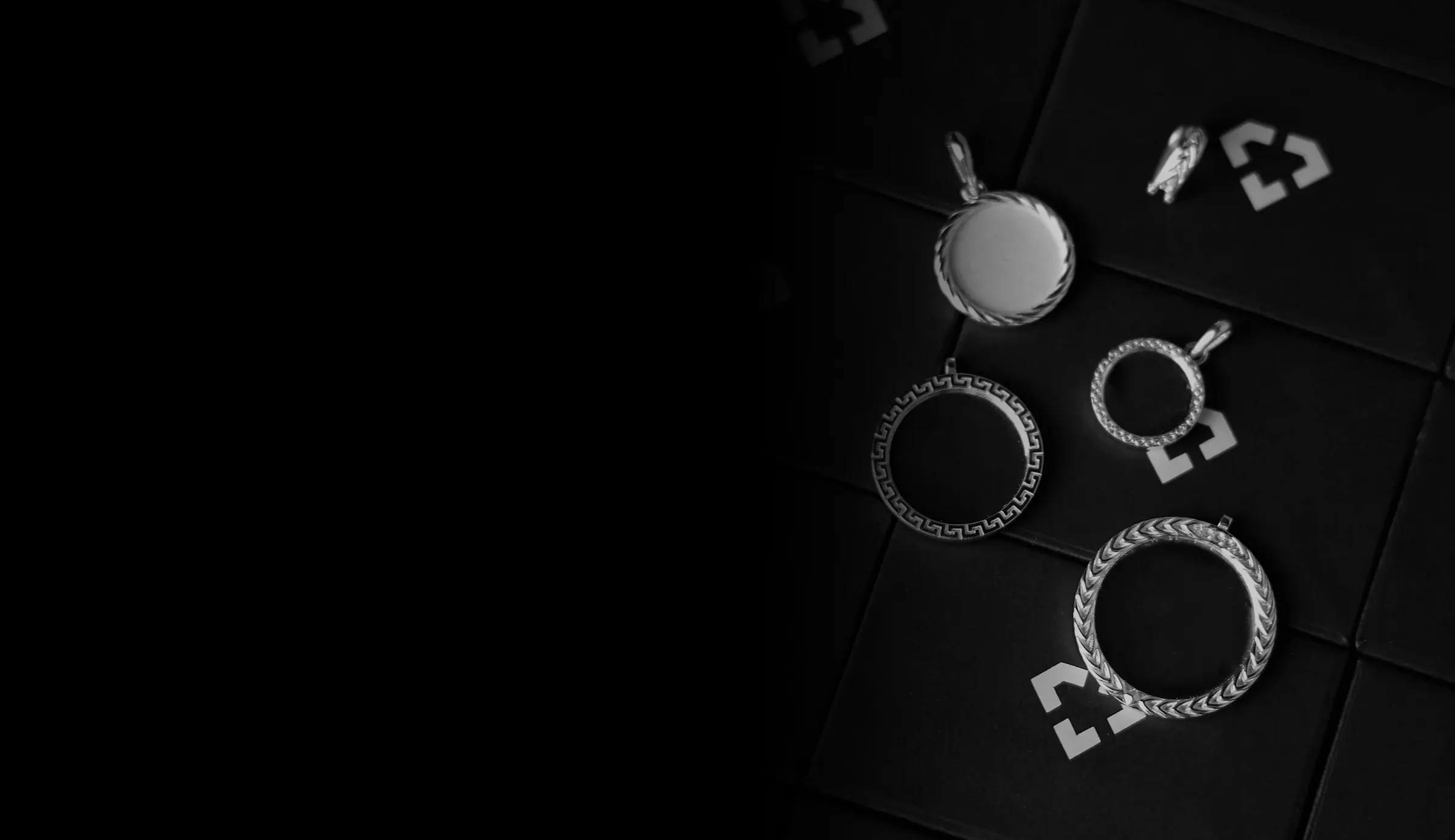 Four M3MORIES relics in silver on the black boxes they ship in: a rope-edged disc, a Greek-key ring, a beaded ring and a wheat-twist ring