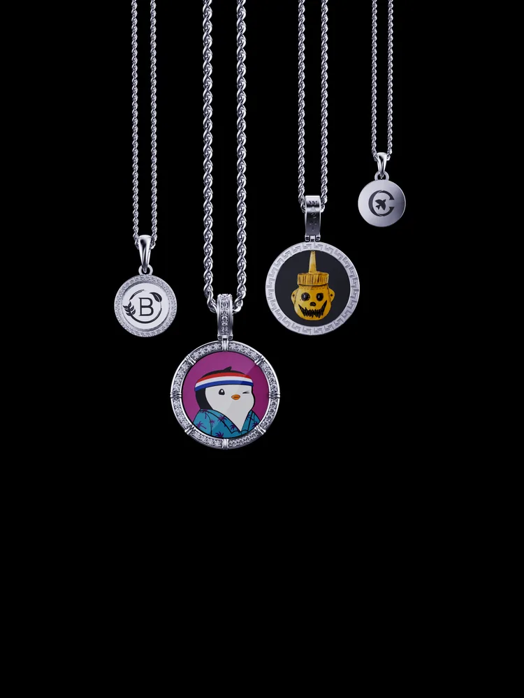 Four M3MORIES pendants on chains, each with a different centerpiece image